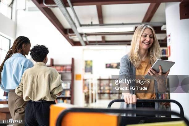 librarian putting books back in the library - bibliotekarie bildbanksfoton och bilder