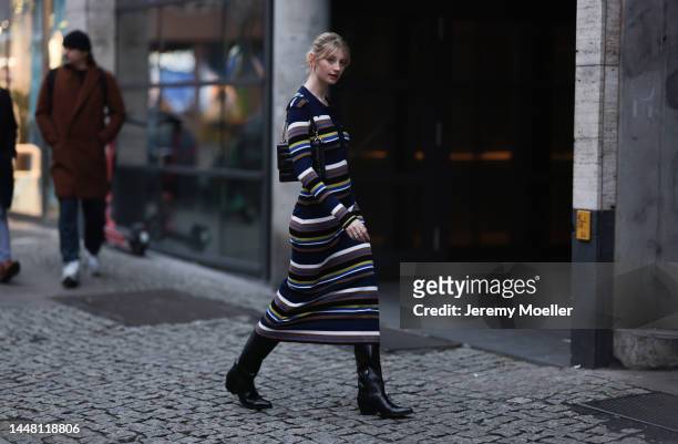 Trixi Giese seen wearing a striped long dress by Munthe, black boots by Iceberg and a black bag by Jimmy Choo on December 06, 2022 in Berlin, Germany.