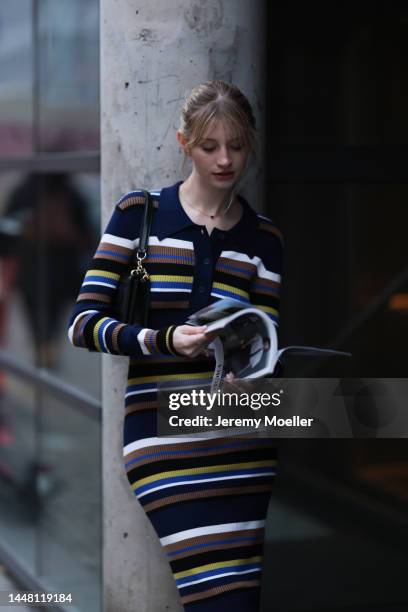 Trixi Giese seen wearing a striped long dress by Munthe, black boots by Iceberg and a black bag by Jimmy Choo on December 06, 2022 in Berlin, Germany.