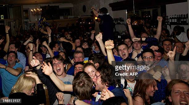 Supporters of Chelsea react to a score of their team as they watch the broadcast of the UEFA Champions League final football match between FC Bayern...