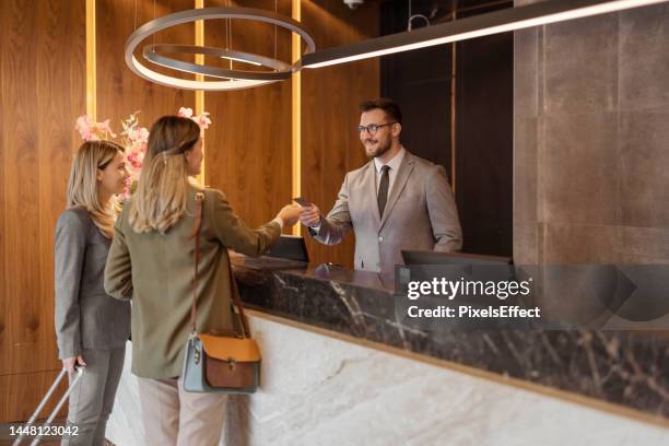 here's your keycard - concierge stock pictures, royalty-free photos & images