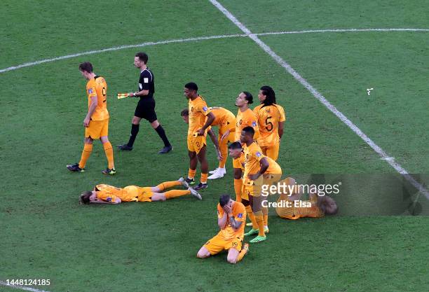 Netherlands players react after the loss in the penalty shootout during the FIFA World Cup Qatar 2022 quarter final match between Netherlands and...