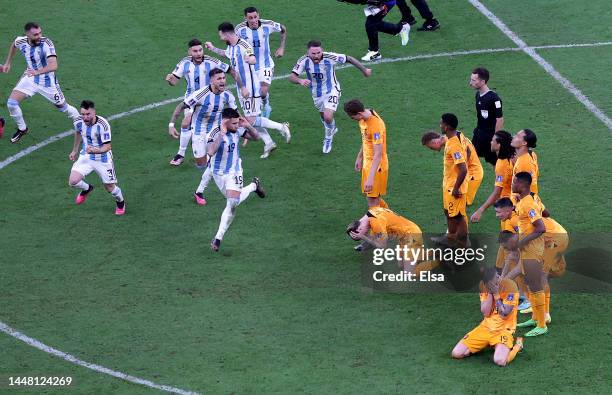 Argentina players celebrate after their win in the penalty shootout as Netherlands players react during the FIFA World Cup Qatar 2022 quarter final...