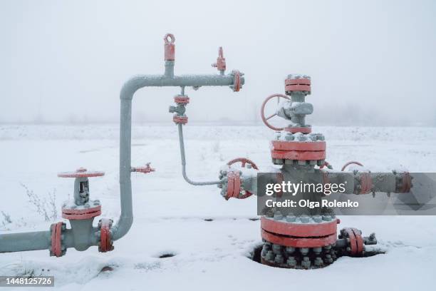 gas and oil compression. natural resource mining, steel pipe with valves working in winter season - compressor stock pictures, royalty-free photos & images