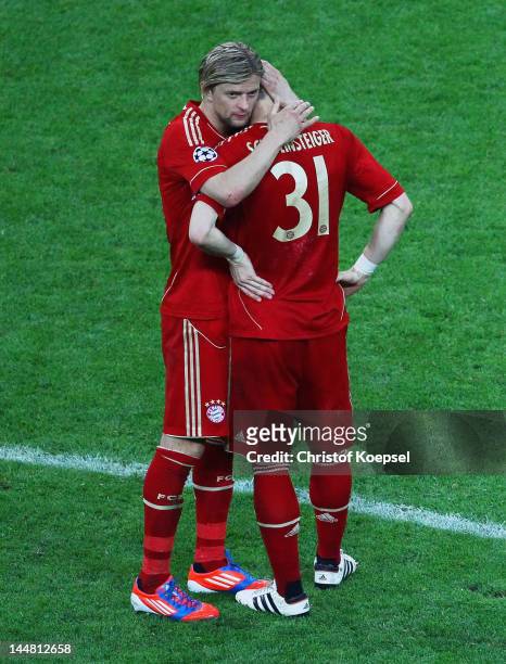 Bastian Schweinsteiger of Bayern is comforted by his team mate Anatoliy Tymoshchuk after failing to score in the penalty shoot out during UEFA...