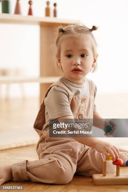 happy toddler playing with sorter - stock photo - carpet samples ストックフォトと画像