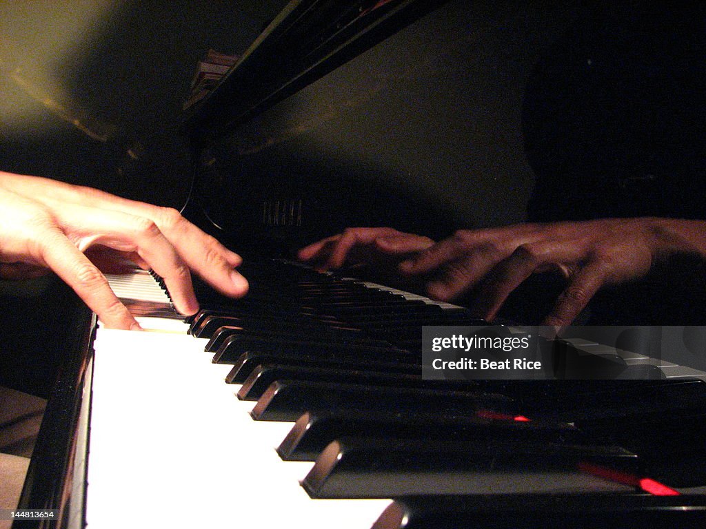 Hands playing piano