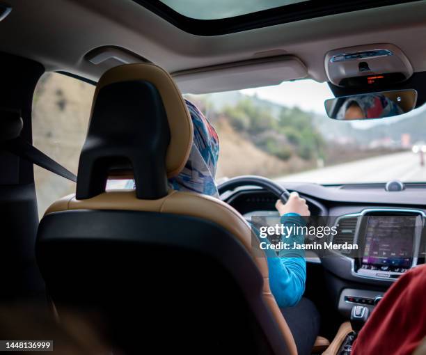 hijabi woman driving car - automotive navigation system stock pictures, royalty-free photos & images