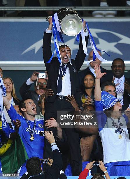 Roberto Di Matteo interim manager of Chelsea lifts the trophy in celebration after their victory in the UEFA Champions League Final between FC Bayern...