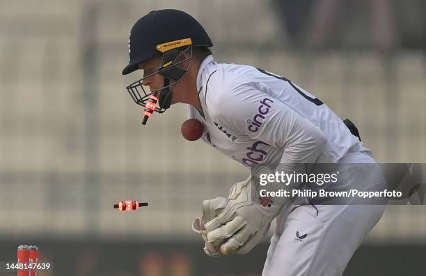 Ollie Pope of England is hit by a zinger bail and also the ball after Mohammad Rizwan was bowled during the second day of the second Test between...