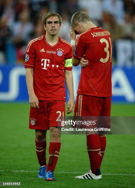 Philipp Lahm and Bastian Schweinsteiger of Bayern Muenchen look dejected after their defeat in the UEFA Champions League Final between FC Bayern...