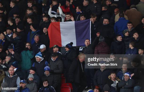 Cardiff City fans hold a France flag up during the Sky Bet Championship between Stoke City and Cardiff City at Bet365 Stadium on December 10, 2022 in...