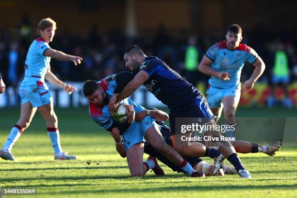 Ollie Smith of Glasgow Warriors is tackled by Nathan Mcbeth of Bath Rugby during the Pool B - Challenge Cup match between Bath and Glasgow Warriors...