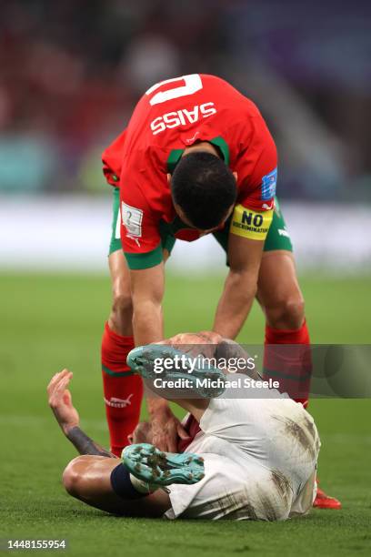 Otavio of Portugal is spoken to by Romain Saiss of Morocco during the FIFA World Cup Qatar 2022 quarter final match between Morocco and Portugal at...