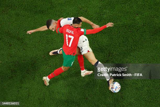 Diogo Dalot of Portugal battles for possession with Sofiane Boufal of Morocco during the FIFA World Cup Qatar 2022 quarter final match between...