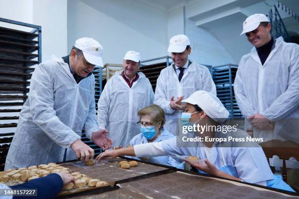 The Minister of Presidency, Interior and Social Dialogue of the Junta de Andalucia, Antonio Sanz, helps an operator to wrap a mantecado during the...