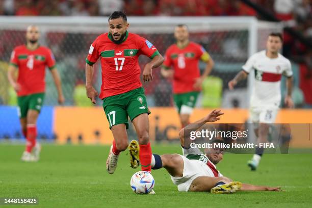 Goncalo Ramos of Portugal tackles Sofiane Boufal of Morocco during the FIFA World Cup Qatar 2022 quarter final match between Morocco and Portugal at...