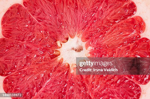 Ruby Red grapefruit background. Composition of half of Ruby Red Grapefruit in Color of the Year 2023 Viva Magenta. Ruby Red grapefruit background. Composition of half of Ruby Red Grapefruit in Color of the Year 2023 Viva Magenta.