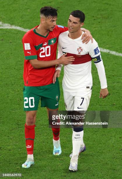 Achraf Dari of Morocco embraces Cristiano Ronaldo of Portugal after the FIFA World Cup Qatar 2022 quarter final match between Morocco and Portugal at...