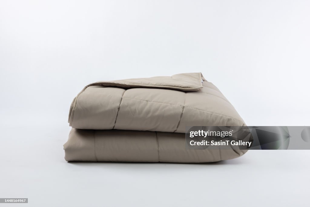 Close-Up Of Light brown Blanket Over White Background