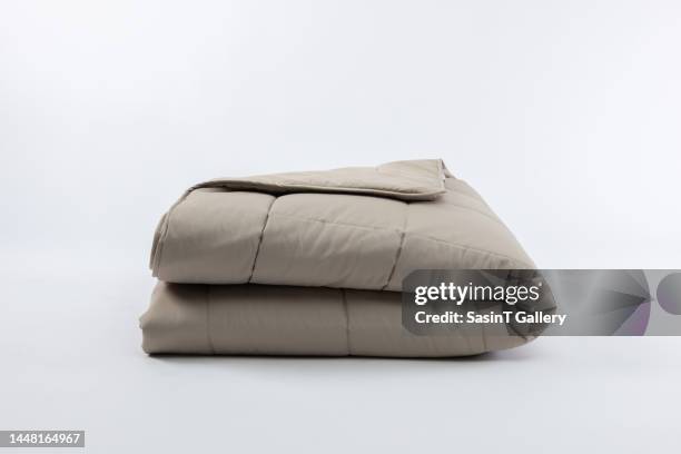 close-up of light brown blanket over white background - deken stockfoto's en -beelden