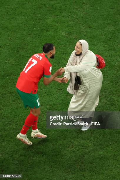 Sofiane Boufal of Morocco celebrates with a family member after the team's 1-0 victory in the FIFA World Cup Qatar 2022 quarter final match between...