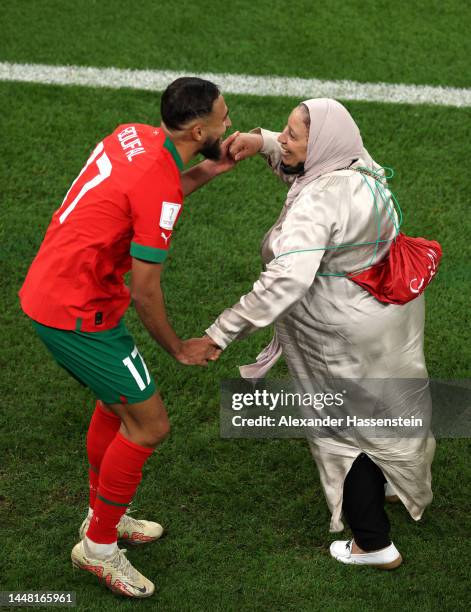 Sofiane Boufal of Morocco celebrates with a family member after the team's 1-0 victory in the FIFA World Cup Qatar 2022 quarter final match between...