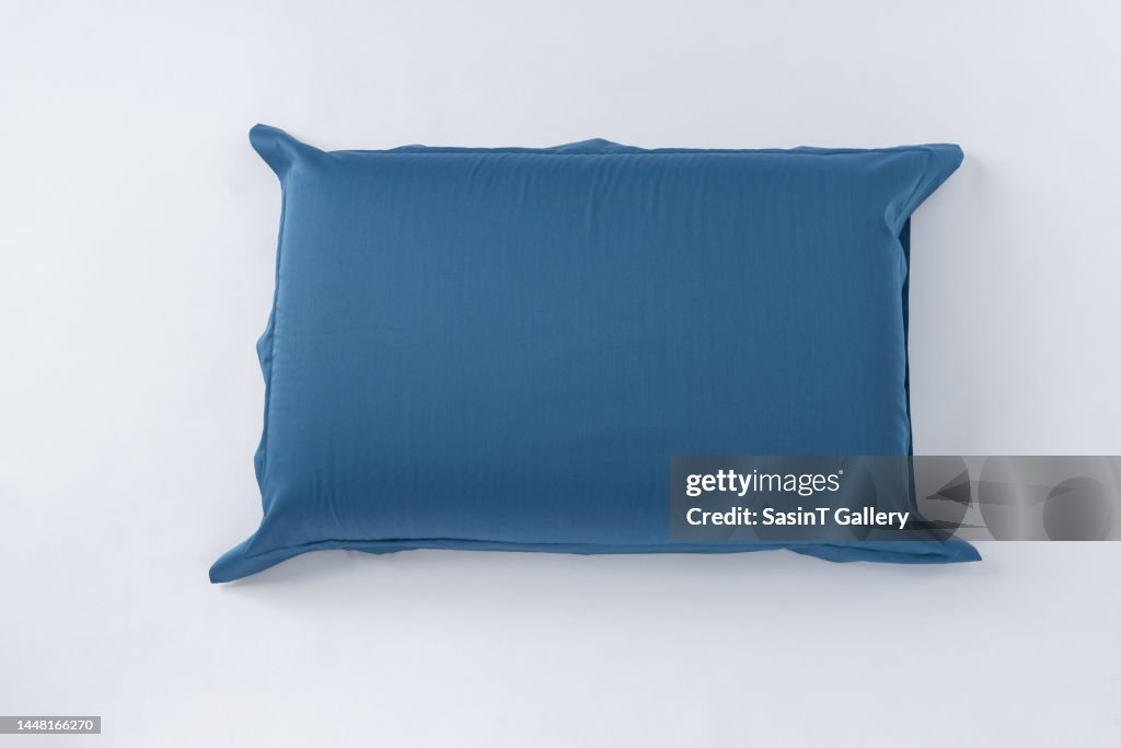 Indigo blue pillow with case isolated on white background.