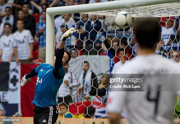 Goalkeeper Joe Cannon of the Vancouver Whitecaps and Alain Rochat watches the shot of Eddie Johnson of the Seattle Sounders hit the back of the net...