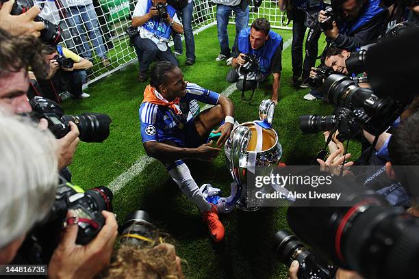Didier Drogba of Chelsea celebrates with the trophy surrounded by photographers after their victory in the UEFA Champions League Final between FC...