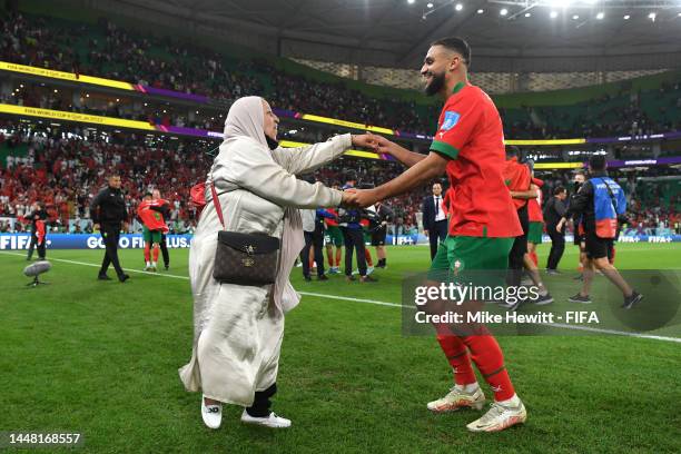 Sofiane Boufal of Morocco celebrates with a family member after the team's 1-0 victory in the FIFA World Cup Qatar 2022 quarter final match between...