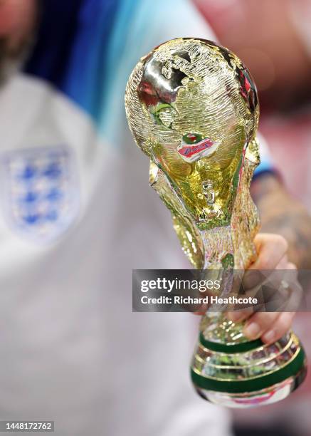 An England fan holds a replica FIFA World Cup trophy prior to the FIFA World Cup Qatar 2022 quarter final match between England and France at Al Bayt...