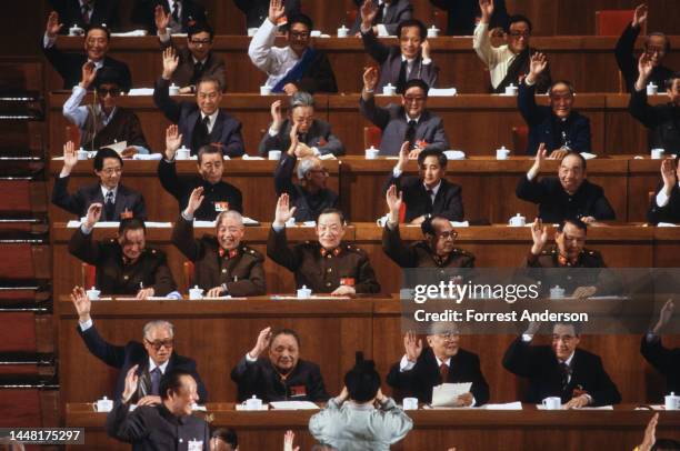 Various Chinese leaders, including Communist Party Secretary Zhao Ziyang , Deng Xiaoping, President Yang Shangkun, and Premier Li Peng raise their...