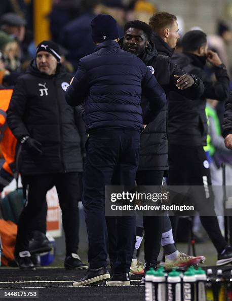 Kolo Toure, Manager of Wigan Athletic, shakes hands with Gary Rowett
