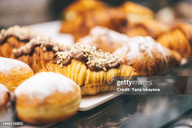 fresh hot and gold french bakery on trays - boulangerie paris ストックフォトと画像