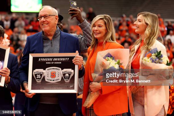 Head Coach Jim Boeheim of the Syracuse Orange is honored during a ring of honor ceremony with his family by his side at the JMA Wireless Dome on...