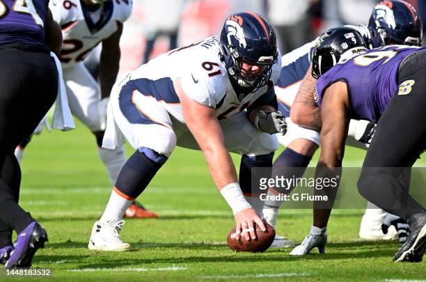 Graham Glasgow of the Denver Broncos lines up over the ball against the Baltimore Ravens at M&T Bank Stadium on December 04, 2022 in Baltimore,...