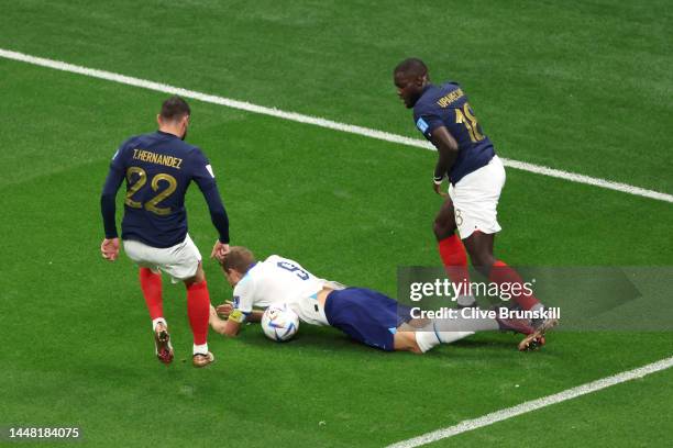 Harry Kane of England is challenged by Dayot Upamecano of France during the FIFA World Cup Qatar 2022 quarter final match between England and France...