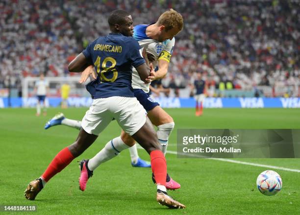 Harry Kane of England is challenged by Dayot Upamecano of France during the FIFA World Cup Qatar 2022 quarter final match between England and France...