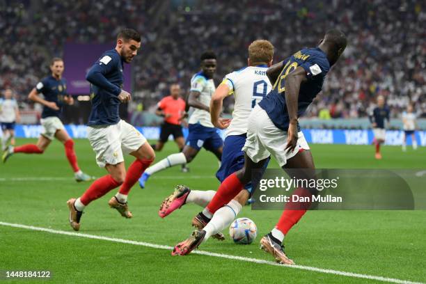 Harry Kane of England is challenged by Dayot Upamecano of France during the FIFA World Cup Qatar 2022 quarter final match between England and France...