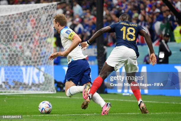 Harry Kane of England is challenged by Dayot Upamecano of France during the FIFA World Cup Qatar 2022 quarter final match between England and France...