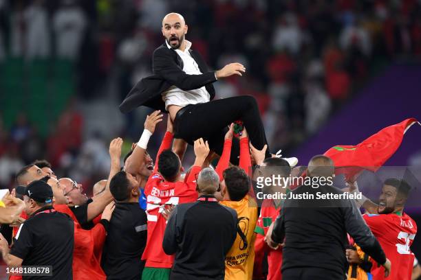 Walid Regragui, Head Coach of Morocco, celebrates with their team after the team's victory during the FIFA World Cup Qatar 2022 quarter final match...