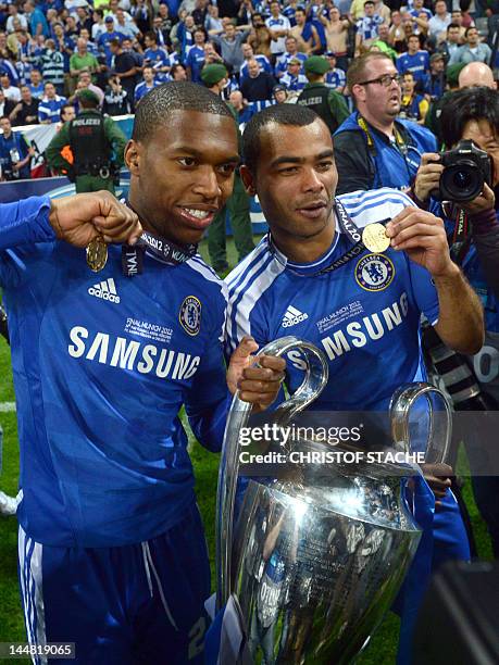 Chelsea's British defender Ryan Bertrand and Chelsea's English defender Ashley Cole pose with the trophy after the UEFA Champions League final...