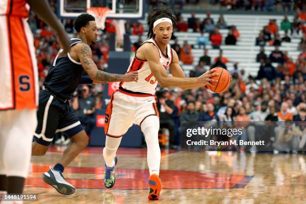 Primo Spears of the Georgetown Hoyas guards Benny Williams of the Syracuse Orange during the second half at the JMA Wireless Dome on December 10,...