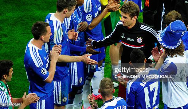 Chelsea's players shake hands with Bayern Munich's German forward Thomas Mueller after the UEFA Champions League final football match between FC...