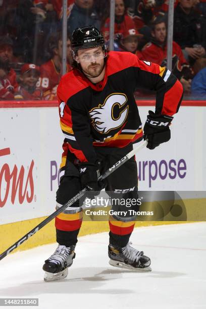 Rasmus Andersson of the Calgary Flames plays the puck against the Minnesota Wild at Scotiabank Saddledome on December 7, 2022 in Calgary, Alberta,...