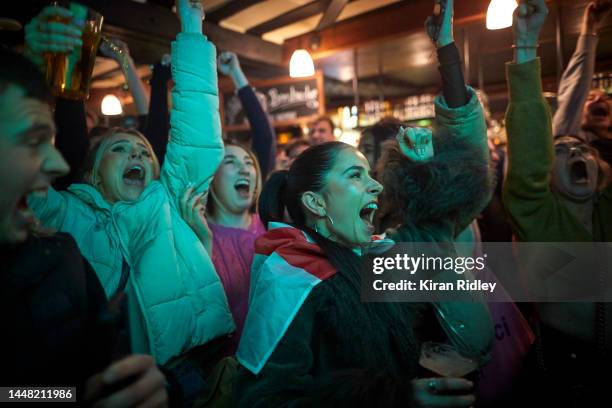 English football fans celebrate Harry Kane's first penalty goal as they watch the World Cup Quarter final between France and England in the...