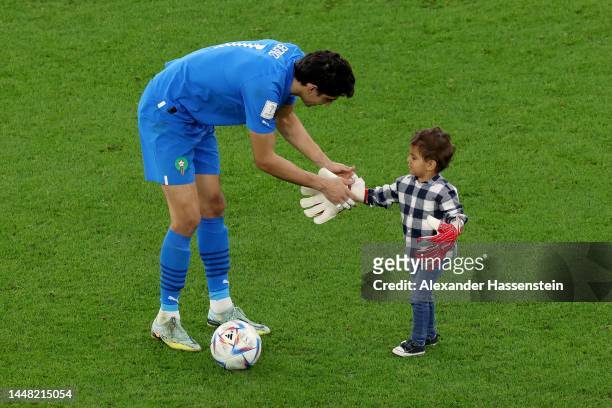 Yassine Bounou of Morocco celebrates the team's 1-0 victory with his son after the FIFA World Cup Qatar 2022 quarter final match between Morocco and...