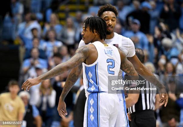 Caleb Love celebrates with Leaky Black of the North Carolina Tar Heels after a dunk against the Georgia Tech Yellow Jackets during the second half of...