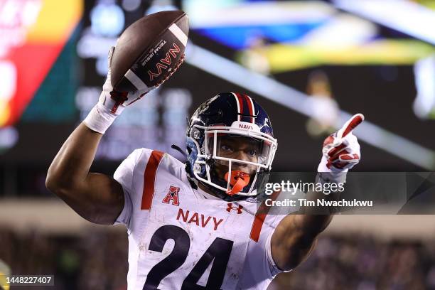 Maquel Haywood of the Navy Midshipmen scores a touchdown during overtime against the Army Black Knights at Lincoln Financial Field on December 10,...